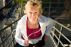 Female With Headphones Running Up Stairs