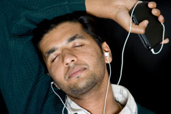 Male Relaxing While Listening To Music