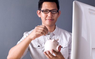 Student Putting Money In The Bank